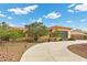 This single-story home features a circular driveway, desert landscaping, and a gray three-car garage at 4185 W Arby Ave, Las Vegas, NV 89118