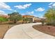 Single-story home features a circular driveway, desert landscaping, and a gray three-car garage at 4185 W Arby Ave, Las Vegas, NV 89118
