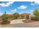 Single-story home features a circular driveway, desert landscaping, and a tile roof in a desert climate at 4185 W Arby Ave, Las Vegas, NV 89118