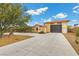 Single-story home features a circular driveway, desert landscaping, and a gray three-car garage at 4185 W Arby Ave, Las Vegas, NV 89118