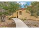 Charming home with desert landscaping, sidewalk, and a warm, inviting entrance flanked by mature trees at 4185 W Arby Ave, Las Vegas, NV 89118