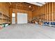 Spacious garage with high ceilings, shelving, and ample space for storage and parking at 4185 W Arby Ave, Las Vegas, NV 89118