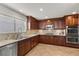 Spacious kitchen boasts stone countertops, custom cabinetry, stainless appliances, and modern lighting at 4185 W Arby Ave, Las Vegas, NV 89118