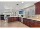 Well-lit kitchen showcasing dark wood cabinets, stainless steel appliances, and stylish decor in an open space at 4185 W Arby Ave, Las Vegas, NV 89118