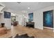 Open-concept living area features a dining area, piano, and stylish decor with brick fireplace at 4185 W Arby Ave, Las Vegas, NV 89118