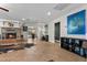 Open-concept living room featuring a cozy fireplace, piano, and lots of natural light at 4185 W Arby Ave, Las Vegas, NV 89118