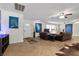Open-concept living room with large windows, tiled flooring, and custom artwork displayed throughout at 4185 W Arby Ave, Las Vegas, NV 89118