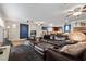 The open-concept living room flows into the kitchen and features dark furniture, fireplace and tile flooring at 4185 W Arby Ave, Las Vegas, NV 89118