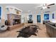 Open-concept living room featuring a cozy fireplace, piano, and lots of natural light at 4185 W Arby Ave, Las Vegas, NV 89118