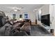 This living room features dark leather furniture, recessed lighting, and contemporary artwork at 4185 W Arby Ave, Las Vegas, NV 89118