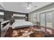 This main bedroom features an accent wall, hardwood floors, and French doors to the outside at 4185 W Arby Ave, Las Vegas, NV 89118
