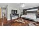 Comfortable main bedroom with hardwood floors, neutral walls, ceiling fan, and lots of natural light at 4185 W Arby Ave, Las Vegas, NV 89118