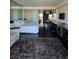 Modern bedroom with mirrored wall, white furniture, and dark wood floors at 4381 W Flamingo Rd # 3109, Las Vegas, NV 89103