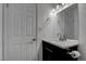 Bathroom features a black vanity with a white countertop and modern fixtures at 4432 Ash Ave, Las Vegas, NV 89110
