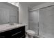 Modern bathroom boasts sleek black vanity, white countertops, and glass-enclosed shower at 4432 Ash Ave, Las Vegas, NV 89110