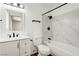 Bright white bathroom with white marble tile, modern vanity, and black accents at 4432 Ash Ave, Las Vegas, NV 89110