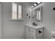 Bathroom features a white vanity with black hardware and a matching framed mirror at 4432 Ash Ave, Las Vegas, NV 89110