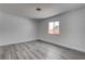 Bedroom featuring a window, fresh white paint, and stylish gray wood floors at 4432 Ash Ave, Las Vegas, NV 89110