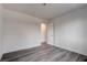 An empty bedroom with gray wood-look floors, light walls and white trim throughout the room at 4432 Ash Ave, Las Vegas, NV 89110