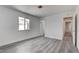 Bedroom with white walls, stylish gray wood floors and a view to the hallway at 4432 Ash Ave, Las Vegas, NV 89110
