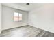 Bright bedroom featuring new gray laminate flooring and white paint at 4432 Ash Ave, Las Vegas, NV 89110