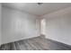 A view of the bedroom featuring stylish gray wood floors, and white walls at 4432 Ash Ave, Las Vegas, NV 89110