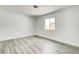 Bright bedroom featuring new gray laminate flooring and white paint at 4432 Ash Ave, Las Vegas, NV 89110