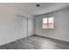 Bedroom featuring wood floors, white walls and a closet and a window at 4432 Ash Ave, Las Vegas, NV 89110