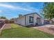 Side view of a cozy single-story home featuring a well-maintained yard and fence at 4432 Ash Ave, Las Vegas, NV 89110