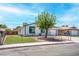 Charming one-story house featuring a well-manicured lawn and a chain-link fence-enclosed yard at 4432 Ash Ave, Las Vegas, NV 89110
