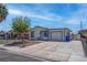 View of the charming home with a fenced front yard, mature tree, and a spacious driveway at 4432 Ash Ave, Las Vegas, NV 89110