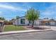 Exterior of a single-story home with a manicured front yard, a mature tree, and gated lawn at 4432 Ash Ave, Las Vegas, NV 89110