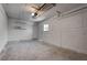 Attached garage features concrete flooring, a window, and an automatic door opener at 4432 Ash Ave, Las Vegas, NV 89110