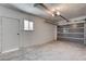 Attached garage features concrete flooring, a window, and an automatic door opener at 4432 Ash Ave, Las Vegas, NV 89110