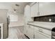 Bright kitchen features modern white cabinets, stone countertops, and stainless steel refrigerator at 4432 Ash Ave, Las Vegas, NV 89110