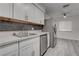 Bright kitchen boasts stainless steel appliances, white cabinets, and a ceiling fan at 4432 Ash Ave, Las Vegas, NV 89110