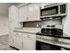 Well-equipped kitchen features stainless steel appliances, white cabinets, and stylish backsplash at 4432 Ash Ave, Las Vegas, NV 89110