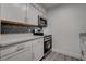 Modern kitchen features white cabinets, stainless steel appliances, and stylish backsplash at 4432 Ash Ave, Las Vegas, NV 89110