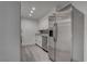Updated kitchen features stainless steel appliances, white cabinets, and gray wood-look flooring at 4432 Ash Ave, Las Vegas, NV 89110