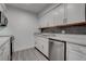 Modern kitchen with white cabinetry, stainless steel dishwasher, and stylish backsplash at 4432 Ash Ave, Las Vegas, NV 89110