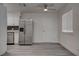Bright living space with updated kitchen, stainless steel refrigerator, and natural light at 4432 Ash Ave, Las Vegas, NV 89110