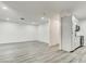 Spacious open-concept living and dining area with modern gray flooring at 4432 Ash Ave, Las Vegas, NV 89110