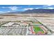Extensive aerial view of a school campus featuring sports facilities, buildings, and large parking area at 4909 Cherokee Run Ct, Las Vegas, NV 89131