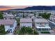 A Las Vegas neighborhood showcasing the home's tile roof and landscaping near the mountains at dusk at 4909 Cherokee Run Ct, Las Vegas, NV 89131