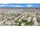 Wide aerial view of a suburban community featuring tree-lined streets, green spaces, and mountain views at 4909 Cherokee Run Ct, Las Vegas, NV 89131