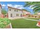 Expansive backyard with lush turf, patio, mature trees, desert landscaping, and privacy fence, great for outdoor activities at 4909 Cherokee Run Ct, Las Vegas, NV 89131
