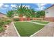 A backyard with grass, gravel and palms in a framed lawn at 4909 Cherokee Run Ct, Las Vegas, NV 89131