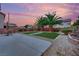 Beautiful backyard featuring well-manicured lawn and desert landscaping, ideal for entertaining at 4909 Cherokee Run Ct, Las Vegas, NV 89131
