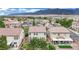 Aerial view of a private backyard with patio, lawn, palm trees, and a covered area at 4909 Cherokee Run Ct, Las Vegas, NV 89131