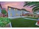 Manicured artificial lawns and desert landscaping in backyard with patio at 4909 Cherokee Run Ct, Las Vegas, NV 89131
